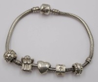 Auktion 348 / Los 1027 <br>Pandora-Armband mit 5 Charms, 925er Silber, zus. 29,5gr., ca. L-16cm.