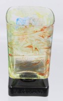 Auktion 355 / Los 10072 <br>Amaretto Glas "di Saronno", bunt auf schwarzen, beschrifteten Stand, H-10,5 cm 6x6 cm